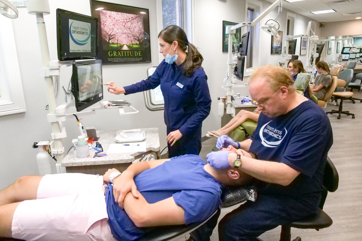 Dr. Demas working on a patient's teeth